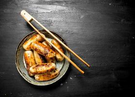 Sausages in an old frying pan. photo