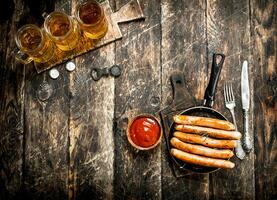 Sausages with cold beer and sauce. photo