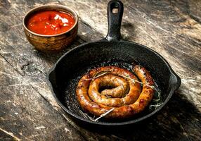 Sausage with tomato sauce. photo