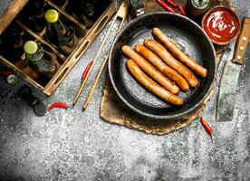 Sausages with a box of beer. photo