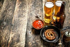 Hot sausages with cold beer. photo