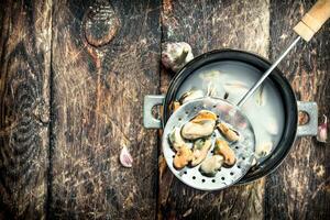 Boiled mussels in a bowl. photo
