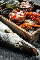 Different seafood on a wooden tray. photo