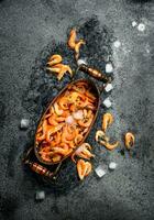 Fresh shrimp in a bowl with ice and fishing net. photo