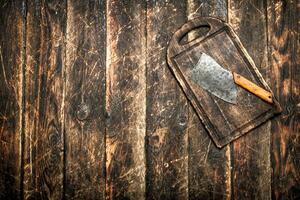 Serving background. Old hatchet on a chopping Board. photo