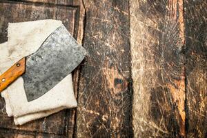 Serving background. Old hatchet on a chopping Board. photo