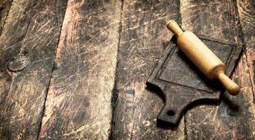 Serving background. Rolling pin on a cutting Board. photo