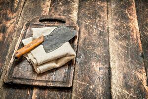 Serving background. Old hatchet on a chopping Board. photo