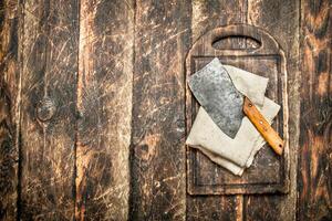 Serving background. Old hatchet on a chopping Board. photo