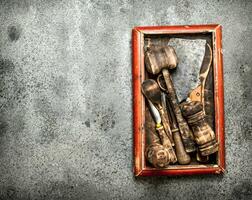 Serving background. Various kitchen tools on the old tray. photo