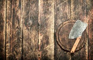 Serving background. Old hatchet on a chopping Board. photo