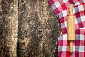 Serving background. Rolling pin with cloth. photo