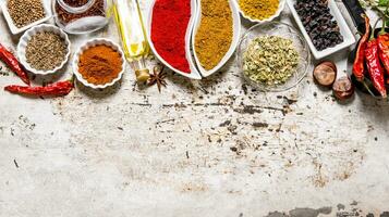 Large set of spices and herbs in the cups. photo