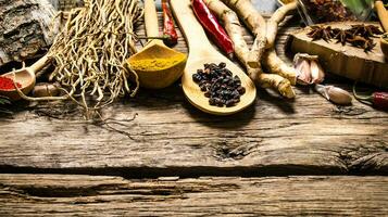 Aromatic spices and herbs on a rustic background. photo