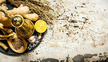 Old mill with spices and herbs on the tray. photo