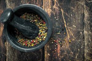 Pepper in a mortar with a pestle. photo