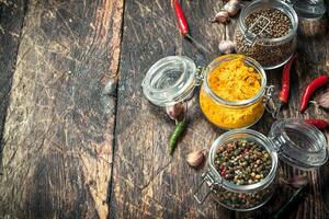 Various spices in glass jars. photo