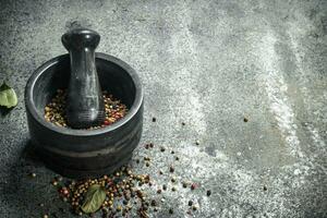 Pepper in a mortar with a pestle. photo