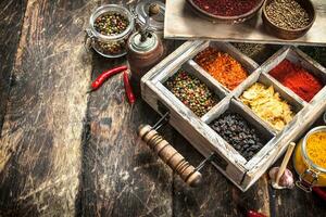 Different spices and herbs in a box. photo