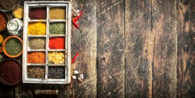 Different spices and herbs in a box. photo