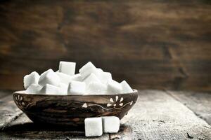 Cubes of sugar in a bowl. photo