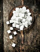 Cubes of sugar in a bowl. photo
