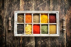 Different spices and herbs in a box. photo