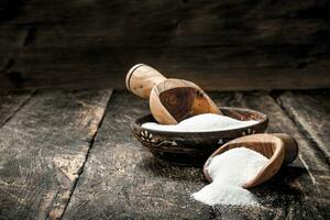 Sugar with a scoop in a bowl. photo