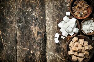 Different types of sugar in bowls. photo