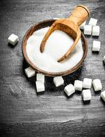 Sugar in a bowl with a scoop. photo