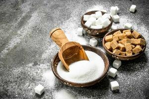 Different kinds of sugar in bowls. photo