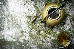 Green tea with a teapot. photo