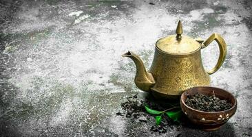 Teapot with black tea. photo