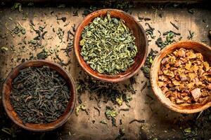 Different kinds of fragrant tea in bowls. photo