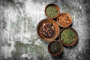 Different kinds of fragrant tea in bowls. photo