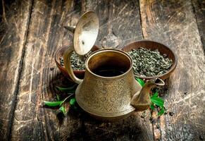 Teapot with fragrant Indian tea. photo