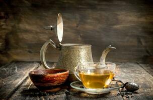 Teapot with fragrant Indian tea. photo