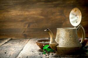 Teapot with fragrant Indian tea. photo