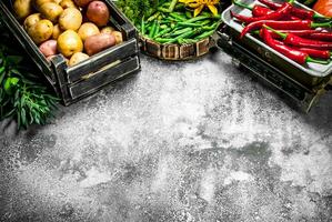 Organic food. Fresh vegetables in a box and chili pepper on scales. photo