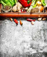 Fresh vegetables . fresh vegetables and herbs in the old tray. On rustic background. photo