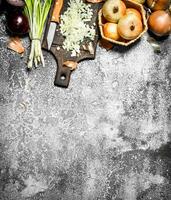 Fresh chopped onion on the old Board. On rustic background. photo