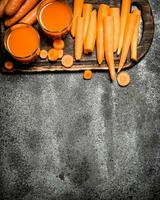 Fresh carrot juice. On rustic background. photo