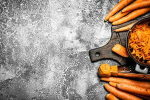 Organic carrots. On rustic background. photo