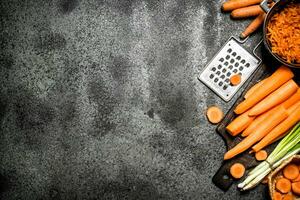 Organic carrots. On rustic background. photo