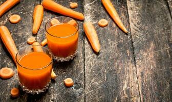 Fresh carrot juice. On the old wooden table. photo