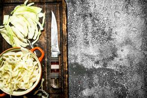 Chopped cabbage. On rustic background. photo