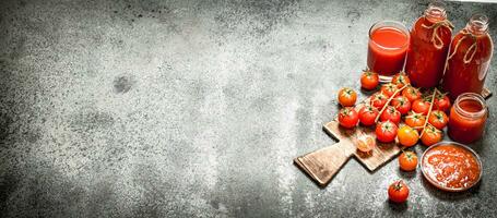 Fresh tomatoes, tomato juice and sauce. photo