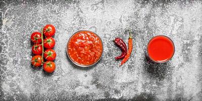 Fresh tomatoes, tomato juice and sauce. photo