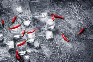 Vodka shots with hot peppers. photo