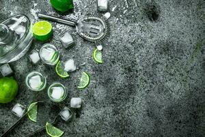 Vodka with pieces of lime and ice cubes. photo